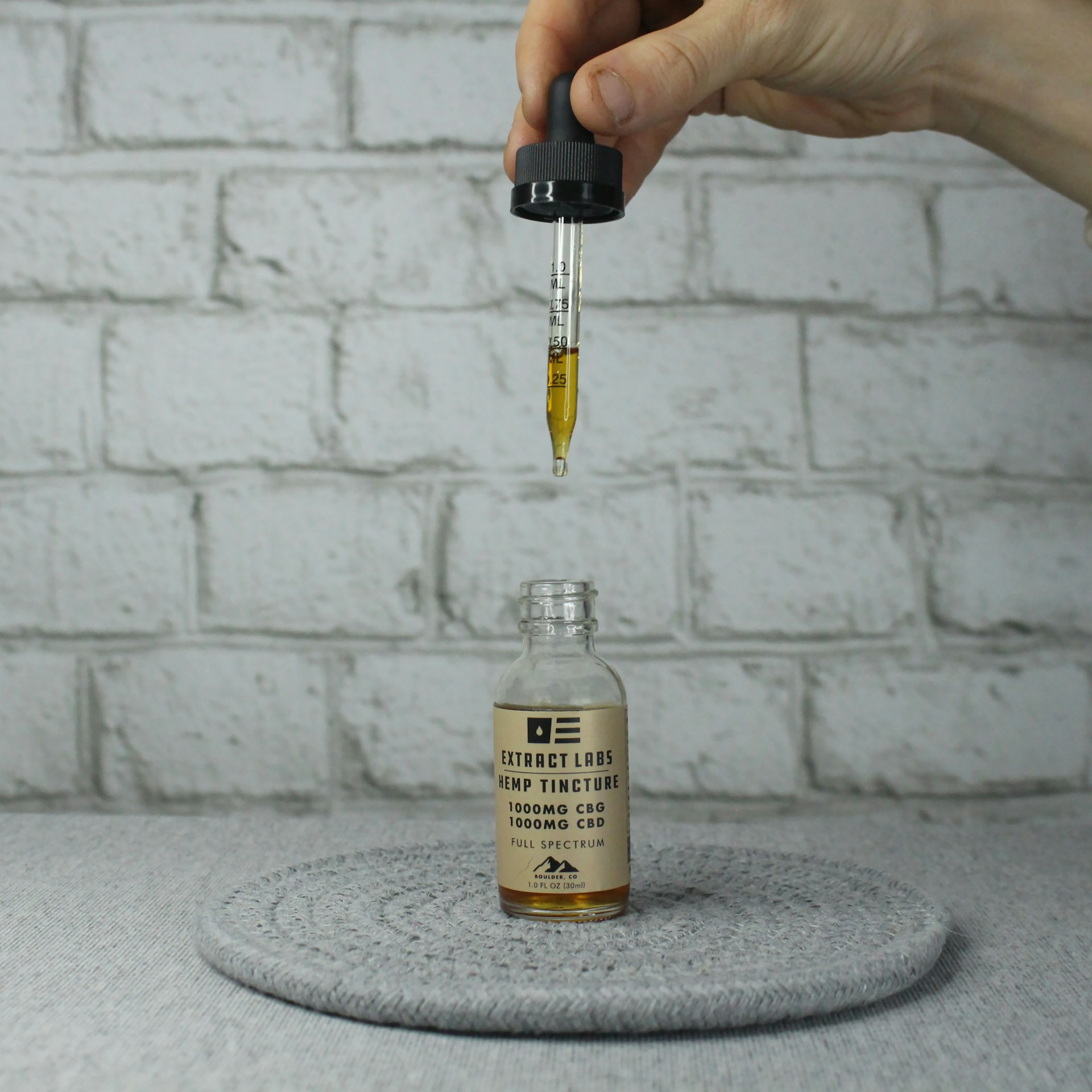 Can a 14 Year-Old Take CBD Gummies | Calmly Rooted A person holding a dropper