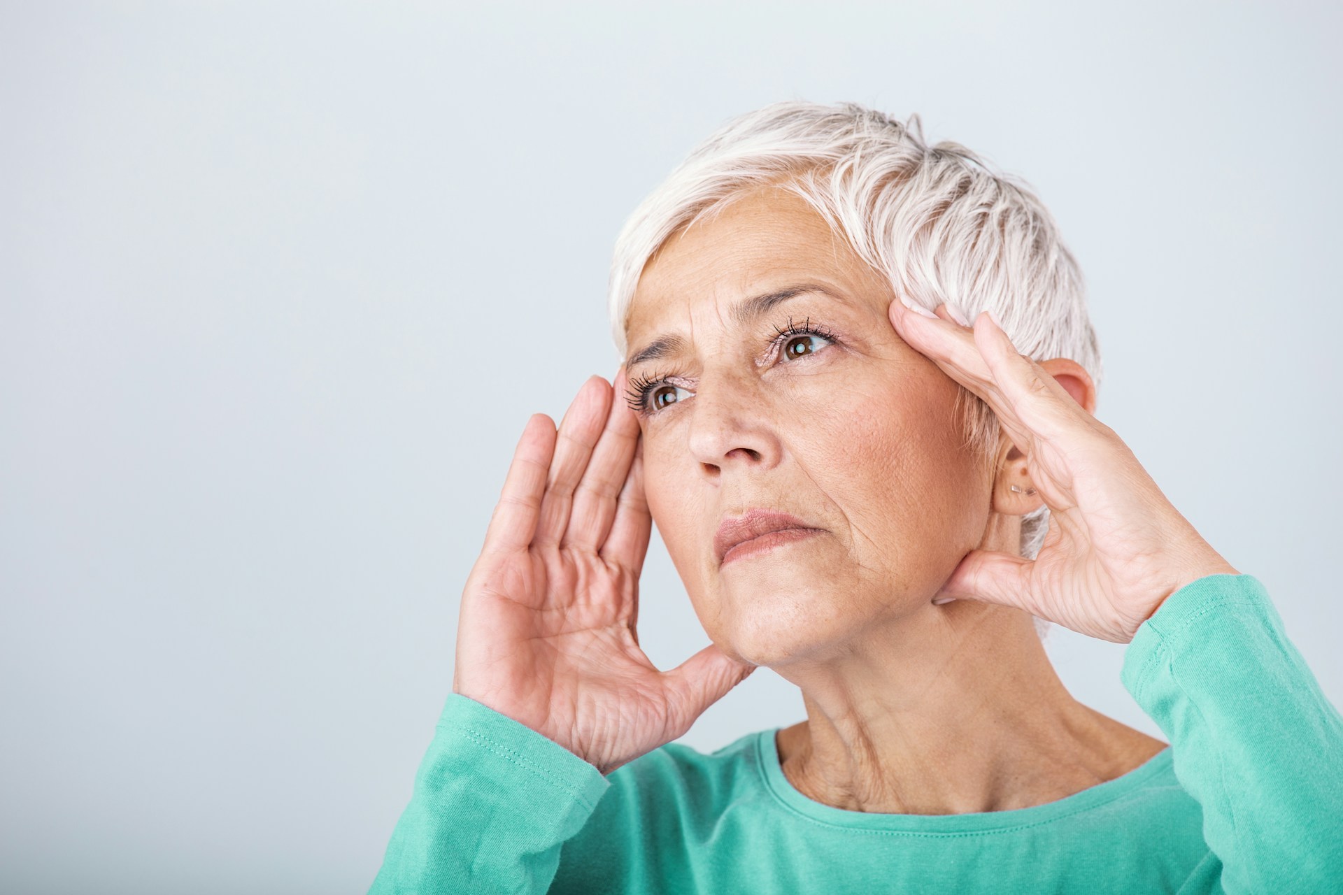 Does Stress Cause Early Menopause | Calmly Rooted An old woman holding her head