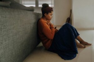 Should I Go to Urgent Care for Anxiety | Calmly Rooted A woman sitting on the floor