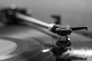 neuroplasticity-music-trivia-calmly-rooted.jpg | Calmly Rooted Close-up of a vintage Shure turntable needle on a vinyl record, representing the connection between music, memory recall, and nervous system regulation.