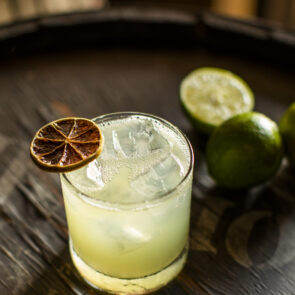 Mushroom Margarita | Calmly Rooted A chilled Mushroom Margarita mocktail with a salted rim and sliced mushroom garnish, representing functional mushroom drinks as a healthy alcohol alternative.