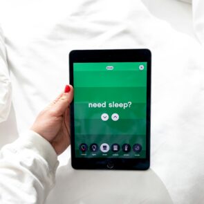 CBD vs CBN for Sleep Wealth Comparison | Calmly Rooted A hand holding a purple balloon with the word SLEEP for a CBN vs CBD sleep guide at Calmly Rooted West Bloomfield.