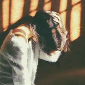 A woman holding her head