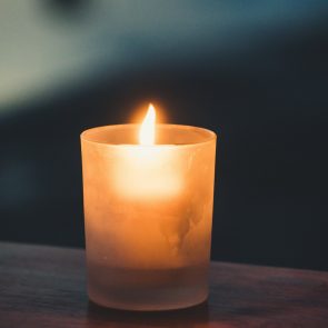 A lit candle on a table