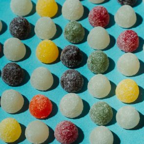 CBD Gummies for Muscle Relaxation | Calmly Rooted Candies sitting on top of a table