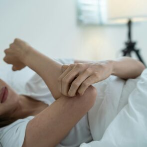A woman scratching her hand