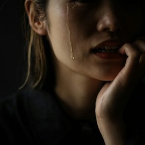 A woman who bites her nails while crying
