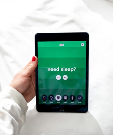 A hand holding a purple balloon with the word SLEEP for a CBN vs CBD sleep guide at Calmly Rooted West Bloomfield.