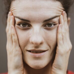 Woman looking stressed and tired due to high nighttime cortisol levels.